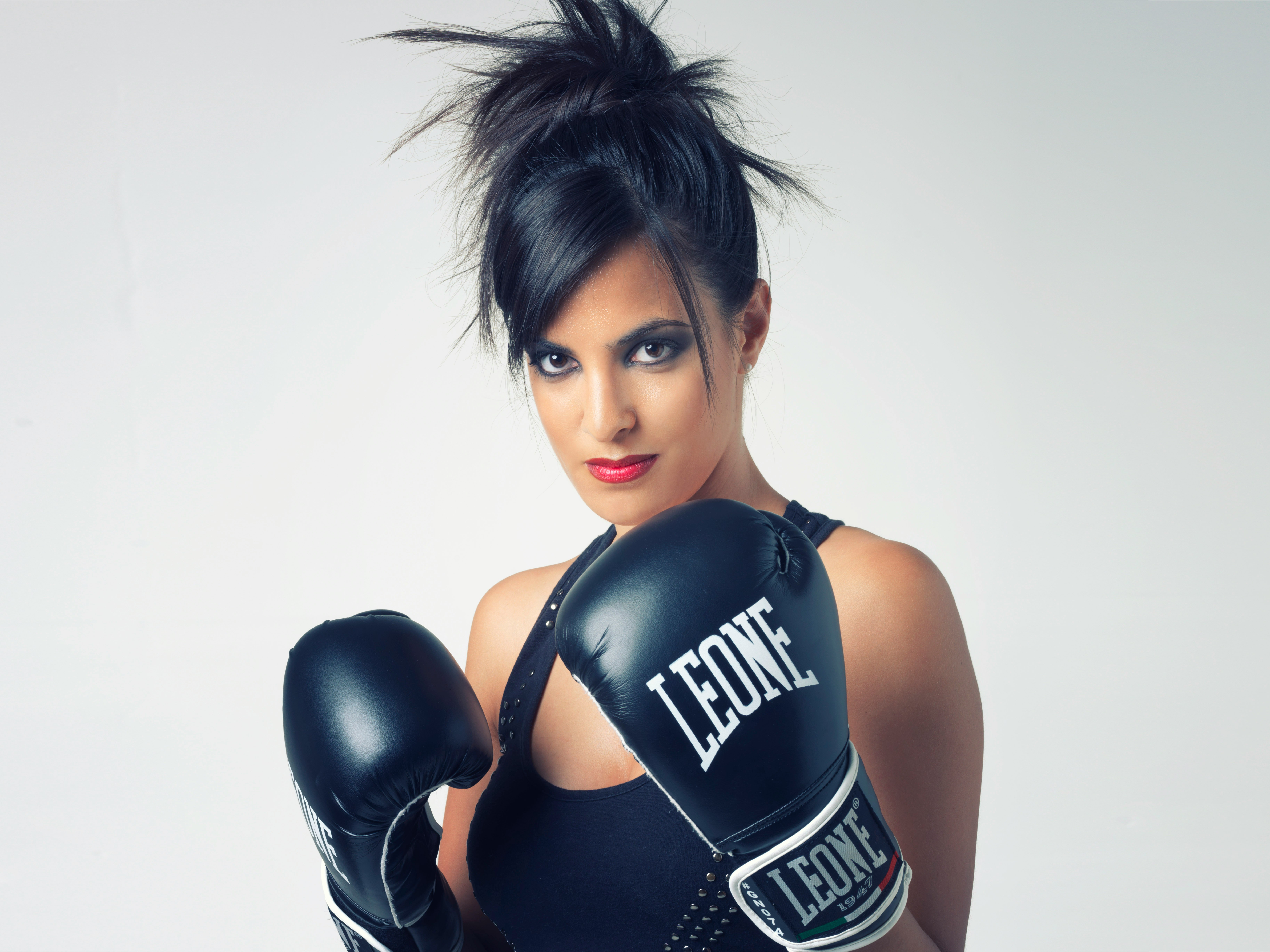 woman wearing black Leone leather boxing gloves